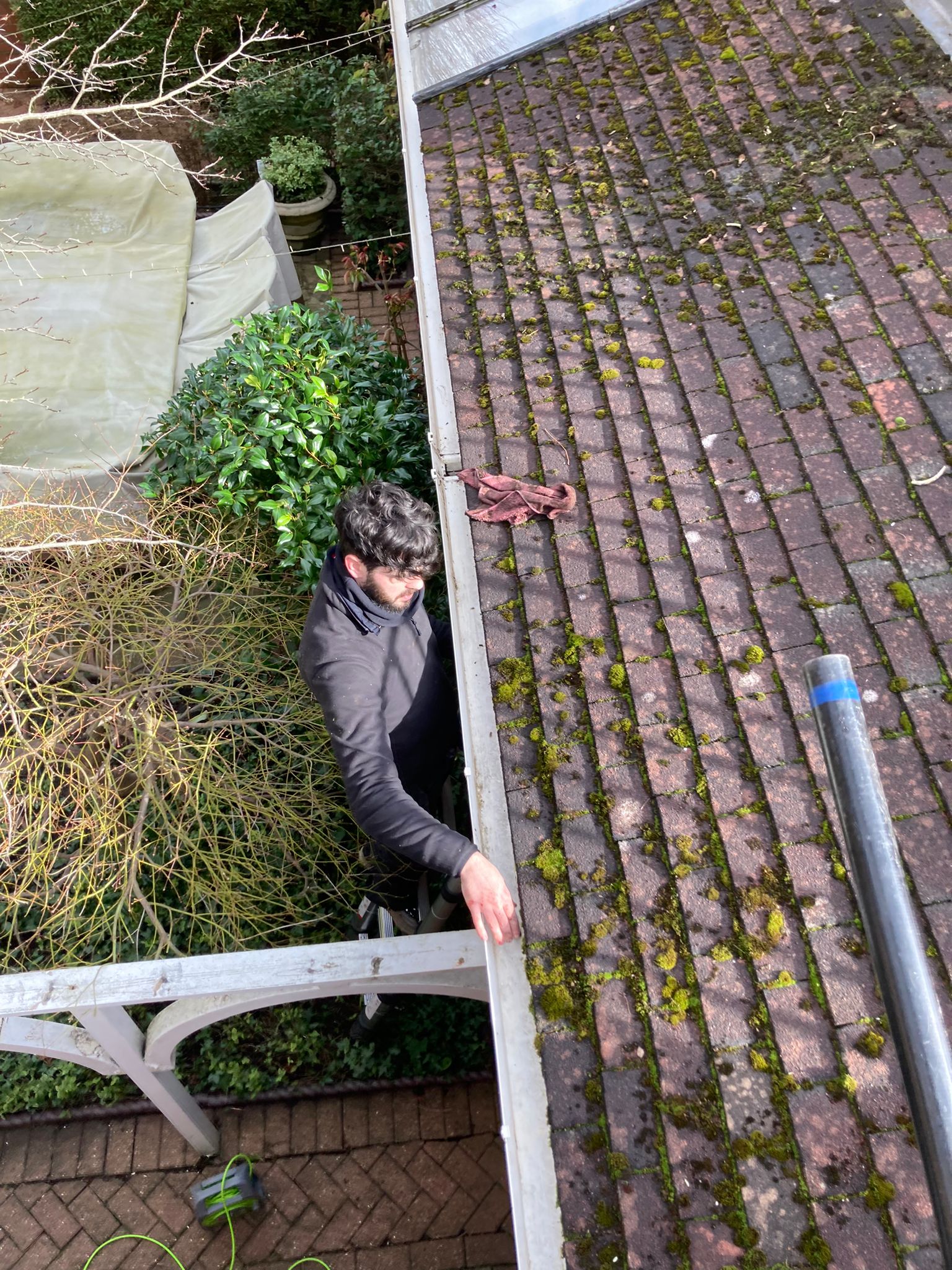 A man cleaning a gutter with some industrial equipment