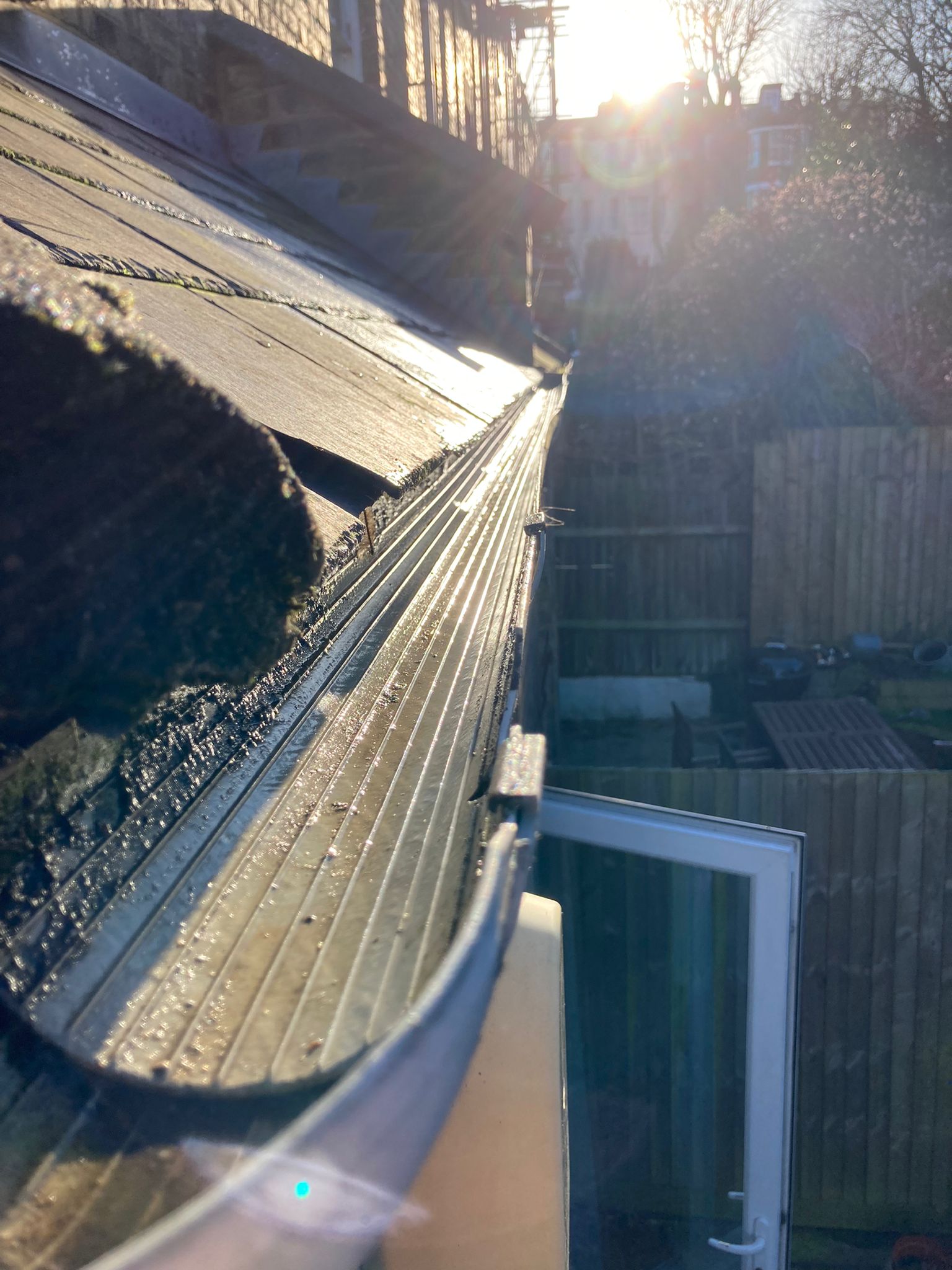 A beautifully clean gutter with the sun shining down.